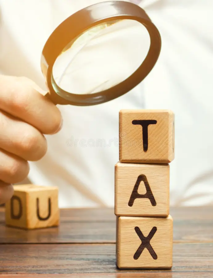 wooden blocks word tax magnifying glass hands businessman concept studying size taxes taxation time to pay 154595898