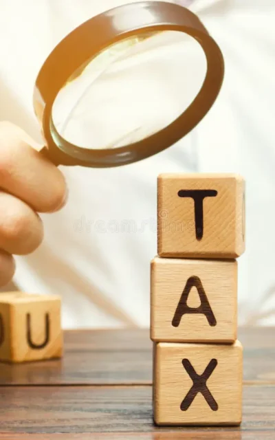 wooden blocks word tax magnifying glass hands businessman concept studying size taxes taxation time to pay 154595898